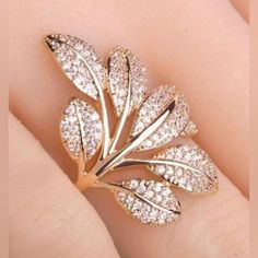 Yellow Gold Colored Leaf Ring With Seven Leaves With Clear Round Stones. It’s A Size 10 And Has No Hallmark, But As Far As I Know It’s Yellow Gold Over Sterling Silver. I’m Not Entirely Sure Because I’ve Never Worn It. I Received It In The Wrong Size. Does Not Come With Gift Box Shown In Pictures. Comes From A Cat Friendly, Smoke Free Home. Make Me An Offer! I Am Highly Motivated To Sell!! Ring Tree, Horn Pendant Necklace, Color Party, Gold Ring Designs, Swarovski Necklace, Flower Leaf, Zircon Ring, Finger Rings, Rhinestone Designs