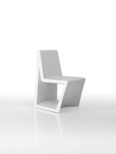 a white chair sitting on top of a white floor