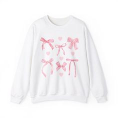 Coquette Pink Bow Sweatshirt for Women Perfect for any occasion, our comfy unisex sweatshirt is a cozy blend of polyester and cotton. It's super soft and keeps its shape, so you can enjoy it wash after wash. No scratchy seams here! 🌟 Made with love from 50% cotton and 50% polyester, it's just the right warmth for colder days (8.0 oz/yd²). The classic fit and crew neckline make it comfy and stylish. Plus, it's super strong with double-needle stitching. 💚 Our tear-away label means no itching. And guess what? It's made with 100% ethically grown US cotton. We care about our planet, too! Gildan is part of the US Cotton Trust Protocol, promising a kind and sustainable production process. 🎨 Oh, and those cool Heather Sport colors? They're 60% polyester and 40% cotton. Stay cozy and feel good a Sales Aesthetic, Coquette Aestethic, Hoodies Ideas, Coquette Crewneck, Kawaii Pink Sweatshirt, Balletcore Aesthetic, Cute Pink T-shirt With Bow Detail, Friend Valentine, Casual Cotton T-shirt With Pink Bow