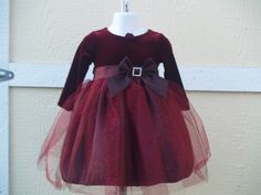 "This is a beautiful, New, Upcycled dress. New dress with Tags! Pictures do not do any justice to this gorgeous dress. This dress comes in a beautiful shade of Burgundy, also available in True Red. The top is Velvet and has a very pretty handmade fabric flower on the round neckline, has long sleeves, and a beautiful taffeta bow with a rhinestone buckle. The top of the skirt is a gorgeous glitter tulle with some hints of red. Dress has a built in crinoline. Please see all pictures!! FOR RED: www. Velvet And Tulle Dress, Glitter Tulle Dress, Ursula Dress, Christmas Gown, Dress Glitter, Upcycled Dress, Thanksgiving Dress, Girls Thanksgiving, Girls Holiday Dresses