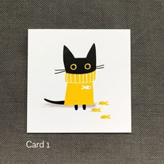 a card with a black cat wearing a yellow sweater and fish on it's tail