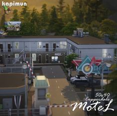 an aerial view of a motel with cars parked on the street and trees in the background