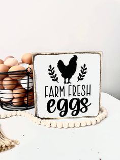 a sign that says farm fresh eggs next to some eggs in a basket on a table