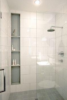 a bathroom with a shower, toilet and shelves