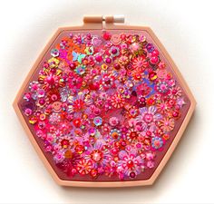 a pink box with lots of colorful buttons on it