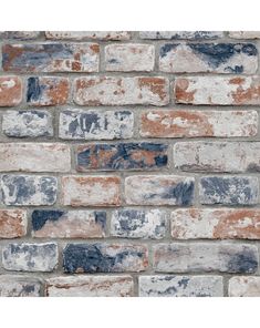 an old brick wall with blue and white paint