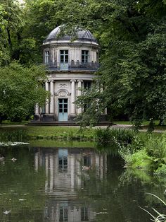 the building is surrounded by trees and water