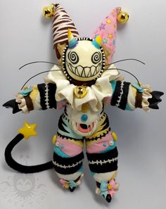 a stuffed animal that is wearing a clown costume