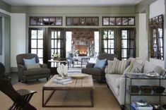 a living room with couches, chairs and a fire place in the fireplace area