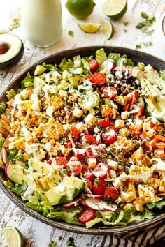 a salad in a bowl with dressing on the side