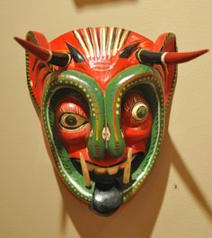 a colorful mask hanging on the wall