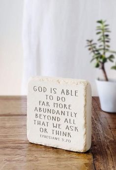 a small stone with the words god is able to do far more abundantly beyond all that we ask or think