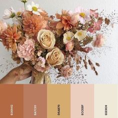 a vase filled with lots of flowers on top of a white wall and color swatches