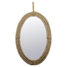 an oval rope mirror hanging on a wall