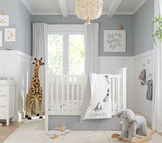 a baby's room with giraffes, crib and other furniture