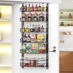 the pantry door is open to reveal an assortment of food and condiments on shelves