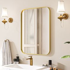 a bathroom with a sink, mirror and lights on the wall next to each other