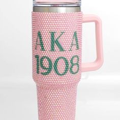 a pink coffee mug with the words aka 9000 on it and green letters