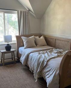 a bed sitting under a window in a bedroom