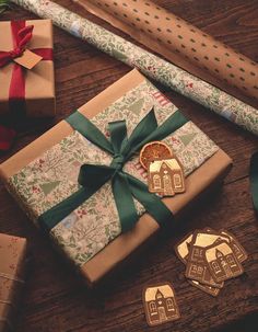 presents wrapped in brown paper and tied with green ribbon on top of a wooden table