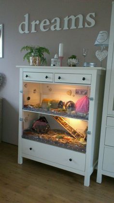 a white dresser with drawers and shelves filled with items