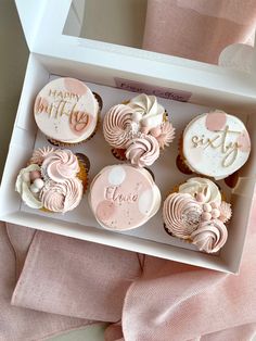 a box filled with lots of cupcakes on top of a table