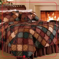 a bed in a room with a fire place next to it and blankets on the bed