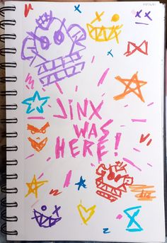 a notebook with some writing on it and colorful doodles in the pages that say ink was here