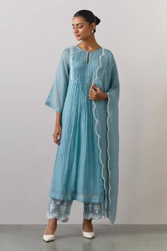 Blue placement embroidered kurta with a round neckline and long sleeves. Paired with an embroidered scalloped pant and dupatta.
Components: 3
Pattern: Embroidered
Type Of Work: Thread
Neckline: Round
Sleeve Type: Three-quarter
Fabric: Chanderi, Tissue Organza
Color: Blue
Other Details: 
Note: Inner worn by the model is not for sale
Occasion: Puja - Aza Fashions The Loom Suits, The Loom Kurtas, Khatwork Kurti, Round Neck Anarkali, Sharara Suits, Kurta Patterns, Kurta Pant Set, Anarkali Dress Pattern, Hand Embroidery Dress