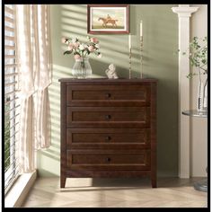 a chest of drawers in a room with green walls