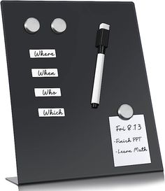 a black and white display board with magnets, pens and paper notes on it