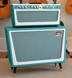 two blue and white amps sitting next to each other