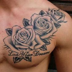 a chest tattoo with two roses and the words live your dreams