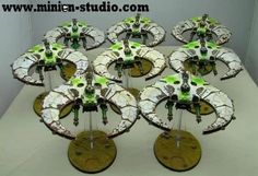 a group of white and green model airplanes