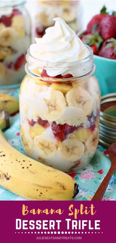 there is a banana split in a jar with whipped cream and cherries on top