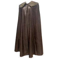 a brown leather cape with fur collar