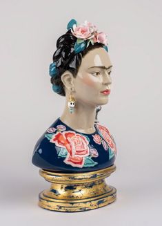 a ceramic busturine with flowers on it's head