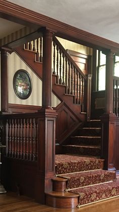 the stairs in this house are made of wood and have red carpeting on them