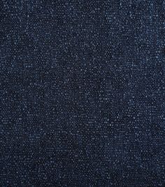 a dark blue textured fabric background with small white dots on the top and bottom