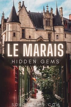 the sign for le marais hidden gems in front of an old castle like building