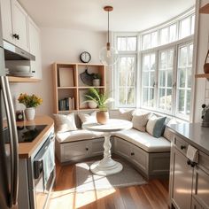 A bright and cozy kitchen corner featuring a small breakfast nook by a large window, with cushioned seating, a round table, and sunlight streaming in, offering a perfect spot to start the day. Small Breakfast Nook Ideas, Small Breakfast Nook, Kitchen Design Modern, Cozy Kitchen