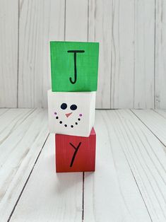 a paper bag with the letter j on it and a snowman's head