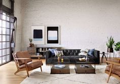 a living room with white brick walls and wooden furniture in the center, along with an area rug on the floor