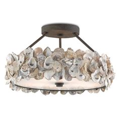 a semi - flush ceiling light with shells on the bottom and an iron frame base