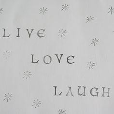 the words live love laugh laugh are written in black ink on a white background with snowflakes