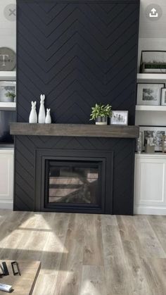 a living room filled with furniture and a fire place in front of a black wall