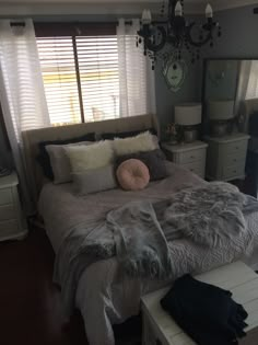 a bed with pillows and blankets in a bedroom