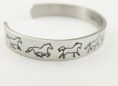 "~ READY TO SHIP ~ NO WAIT TIME Stainless Steel Open Cuff Style Bangle Bracelet Outside cuff : Horses Engraved Various Gait Inscribed Inside : \" Just A Girl Who Loves Horses \" - Made From - Stainless Steel which is hypo allergenic, it doesn't rust, change colour or tarnish. ~ Shiny, durable, Stainless Steel ~ Stronger than Aluminum Bracelets - Measures approximately 6\" by 3/8 \" - Has some flexibility to adjust fit ~ Purchasing as a Gift - if you would like a note written to accompany your gi Adjustable Horse Design Bracelet, Equestrian Bracelet Jamies Horse Jewelry, Adjustable Sterling Silver Horse Design Jewelry, Silver Horse Design Bracelet Jewelry, Collectible Silver Horse Design Jewelry, Aluminum Bracelets, Equestrian Jewelry, Gifts For Horse Lovers, Charm Bangle