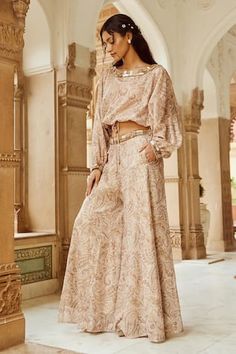 Beige tie up crop top with paisley print and floral, beads, stones, pearls, sequins embroidered neckline. Paired with coordinating flared pant and attached side pockets. - Aza Fashions Bohemian Sequin Sets For Reception, Bohemian Festive Wide Leg Sets, Festive Bohemian Paisley Print Sets, Festive Paisley Print Sets, Tie Up Crop Top, Rhea Kapoor, Mira Rajput, Sanya Malhotra, Jacqueline Fernandez