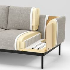 a couch that has its back open and is sitting on a table